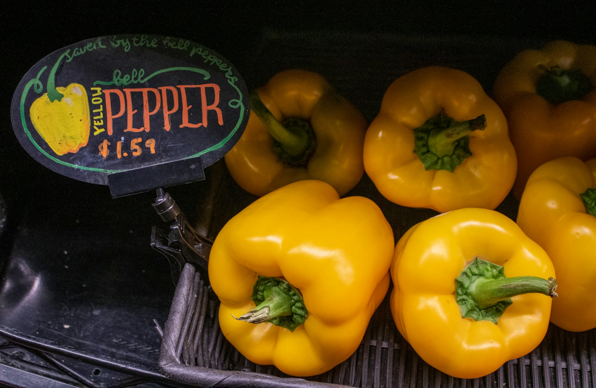 Yellow bell peppers on display at a store.
